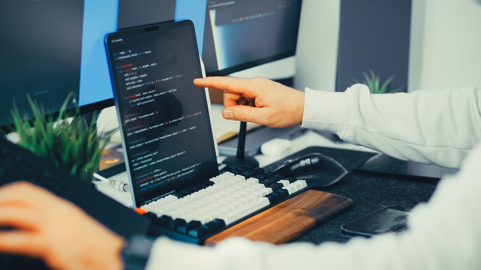 Programista pracuje nad kodem Java na laptopie i monitorze w biurze