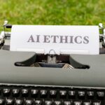 Jak regulacje UE zmienią rozwój sztucznej inteligencji w produktach chmurowych Stara maszyna do pisania na dworze z kartką z napisem AI ethics